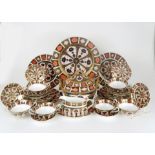 A ROYAL CROWN DERBY DINNER SERVICE comprising a soup tureen and cover, six soup coupes and