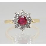 A RUBY & DIAMOND FLOWER RING mounted throughout in 18ct yellow gold, set with estimated approx 0.