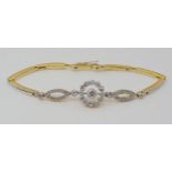 A VINTAGE DIAMOND BRACELET the sprung links are stamped 18ct and are white metal topped, set with
