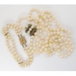 A PEARL NECKLACE AND BRACELET with a 14k gold pearl and turquoise clasp with special safety