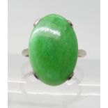 A CHINESE GREEN HARDSTONE RING with un-hallmarked fine white metal mount, the hardstone dimensions