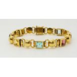 AN 18CT GOLD MIXED GEM SET BRACELET to include peridot, amethyst and aquamarine, length 18cm, weight