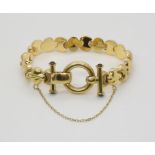 AN 18CT GOLD BRACELET With fancy shiny and textured links with onyx terminals to the clasp. Length