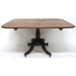 A 19TH CENTURY MAHOGANY TILT TOP LOO TABLE with rectangular top on turned column on quadrupedal base