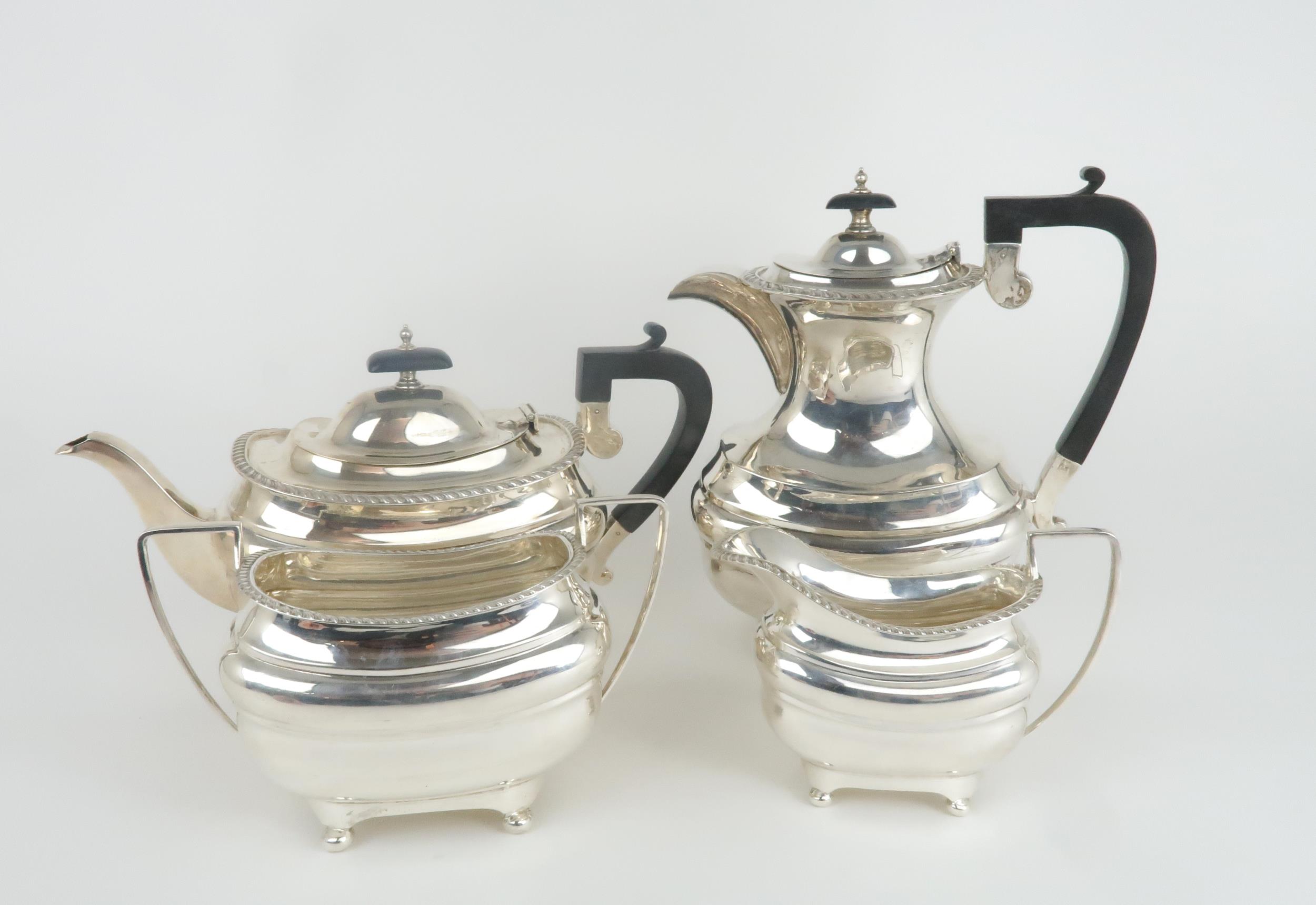 A GEORGE V SILVER FOUR PIECE TEA SERVICE by Walker & Hall, Sheffield 1930, of baluster form, with