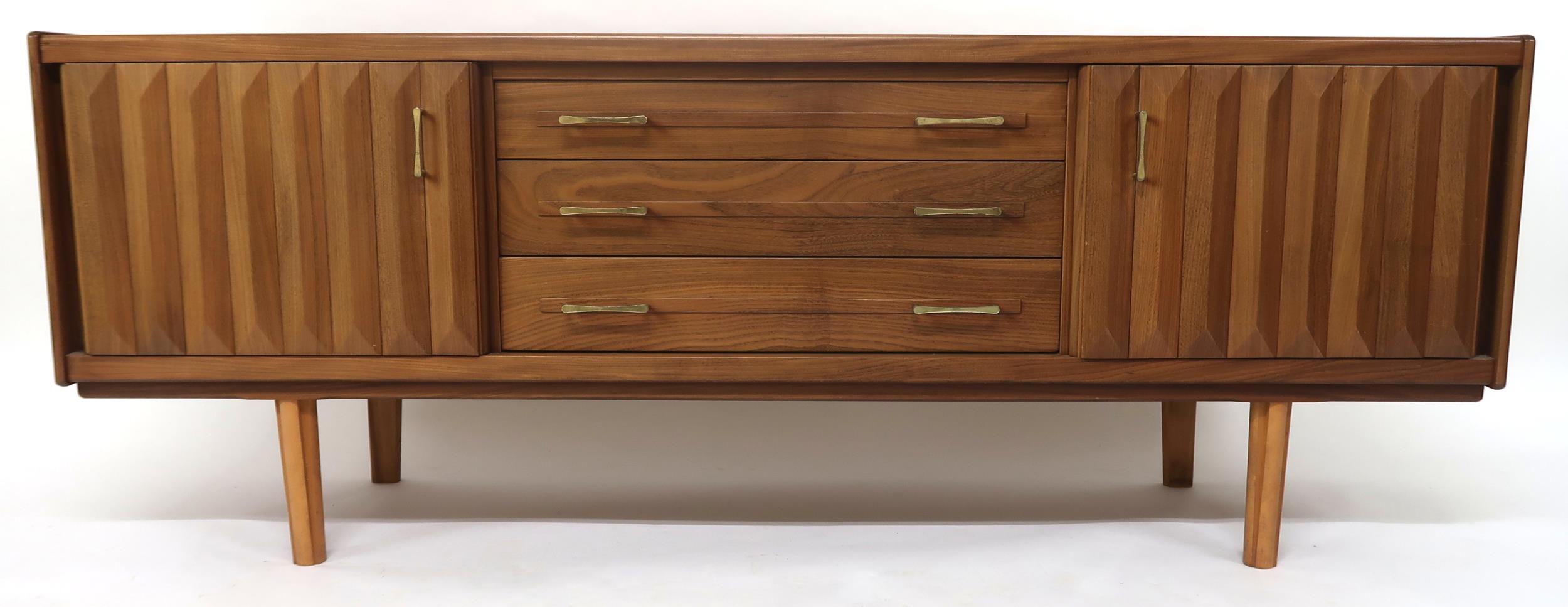 A MID 20TH CENTURY TEAK SIDEBOARD with three long central drawers flanked by cabinet doors with