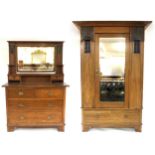 A HARRIS LEBUS ARTS & CRAFTS TWO PIECE BEDROOM SUITE comprising wardrobe with shaped cornice over
