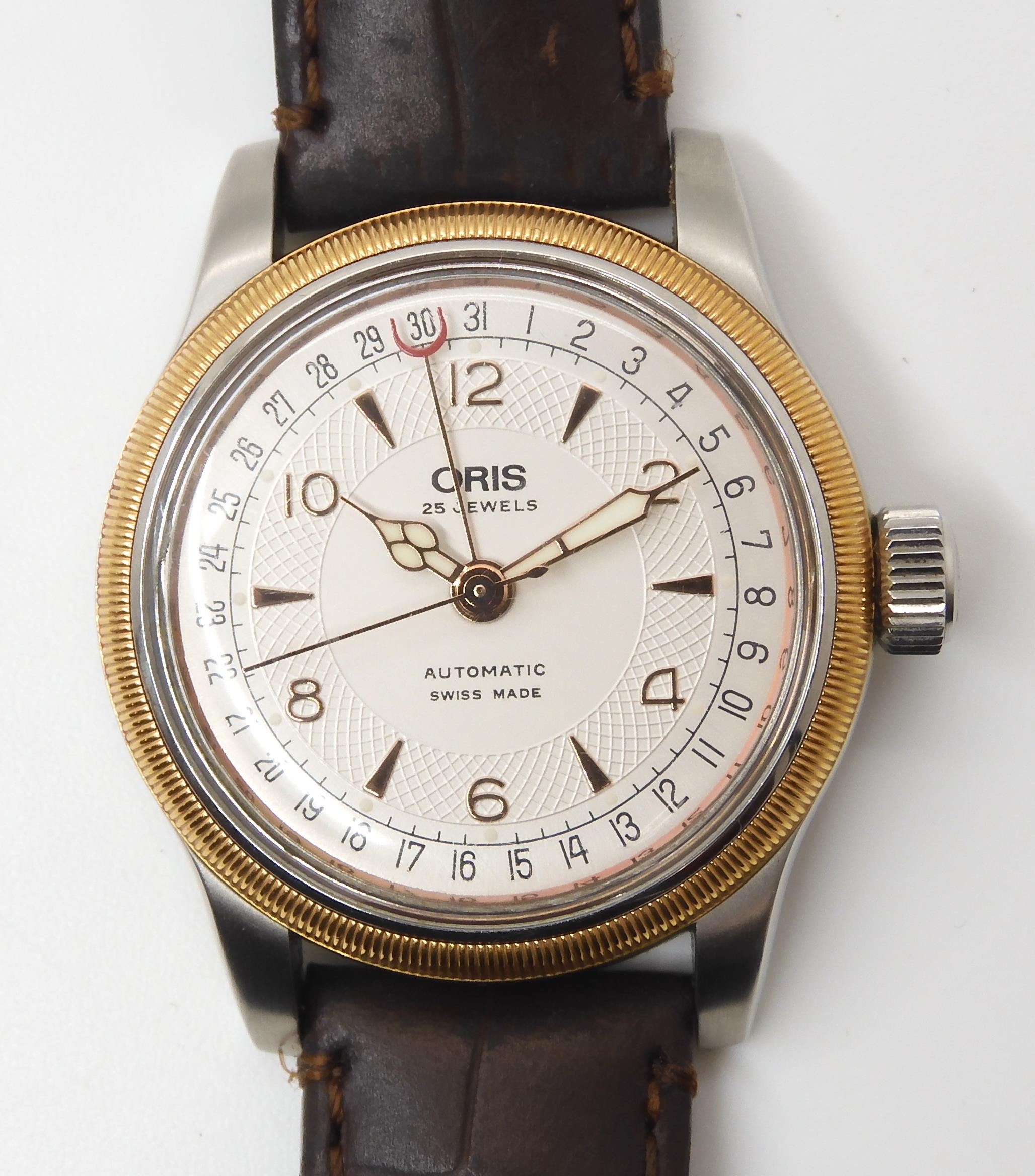 AN ORIS AUTOMATIC WRISTWATCH with two tone cream textured dial with gold coloured chevron and Arabic