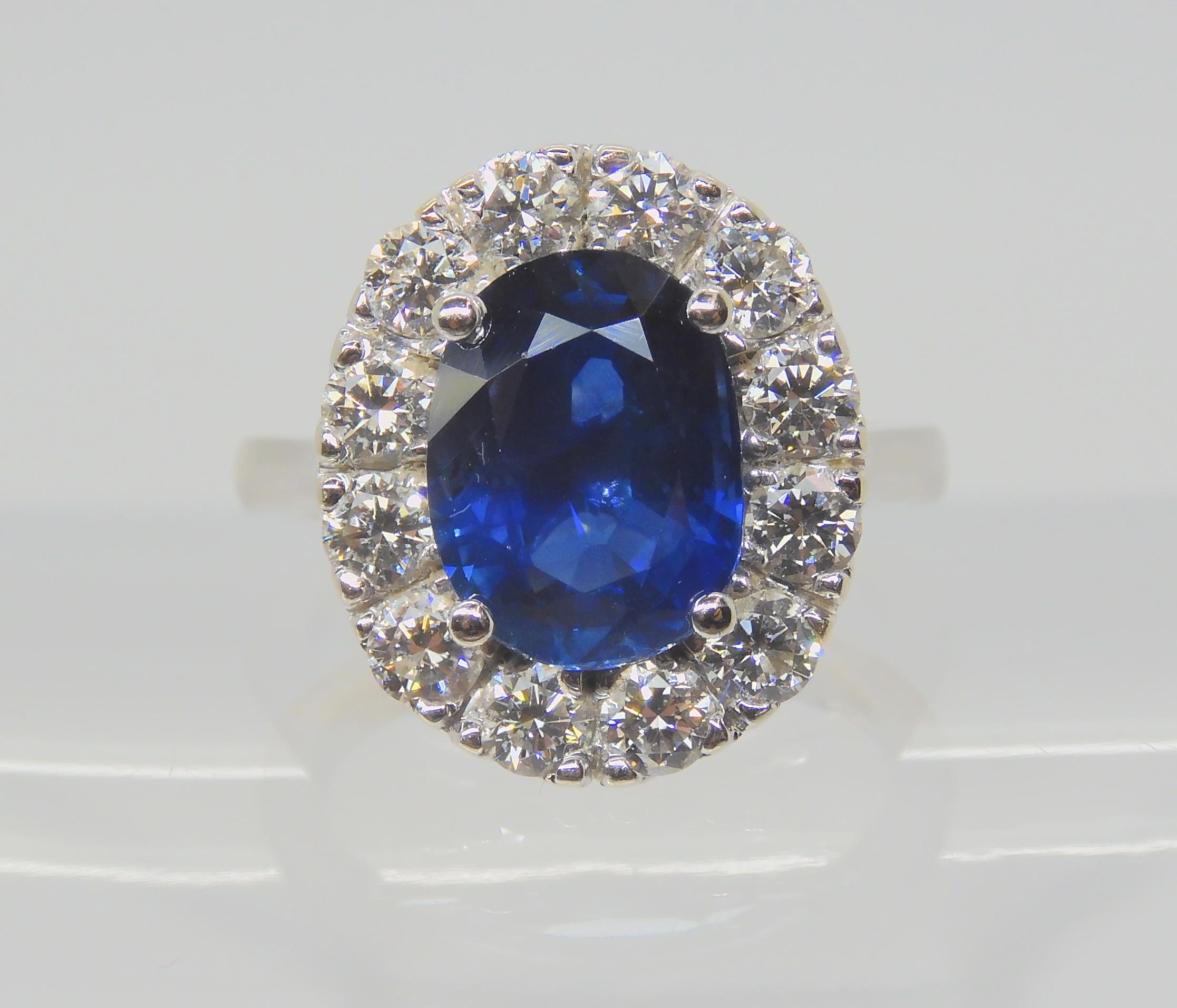 A SAPPHIRE AND DIAMOND CLUSTER RING set throughout in 18ct white gold, set with an oval mixed cut - Image 2 of 9