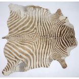 A 20TH CENTURY BROWN AND WHITE PRINTED COWHIDE RUG rug is 182cm long x 182cm wide Condition Report: