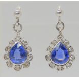 A PAIR OF SAPPHIRE & DIAMOND EARRINGS The pear shaped sapphires are approx 6.8mm x 5.4mm, surrounded