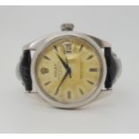 A ROLEX OYSTER PERPETUAL DATE with cream patinaed dial, dagger indexes and date aperture. Diameter