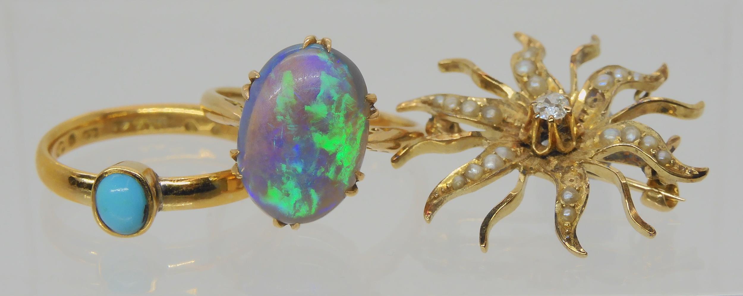 AN OPAL RING AND OTHER ITEMS The solid black opal has lively green, purple and blue colour play, and