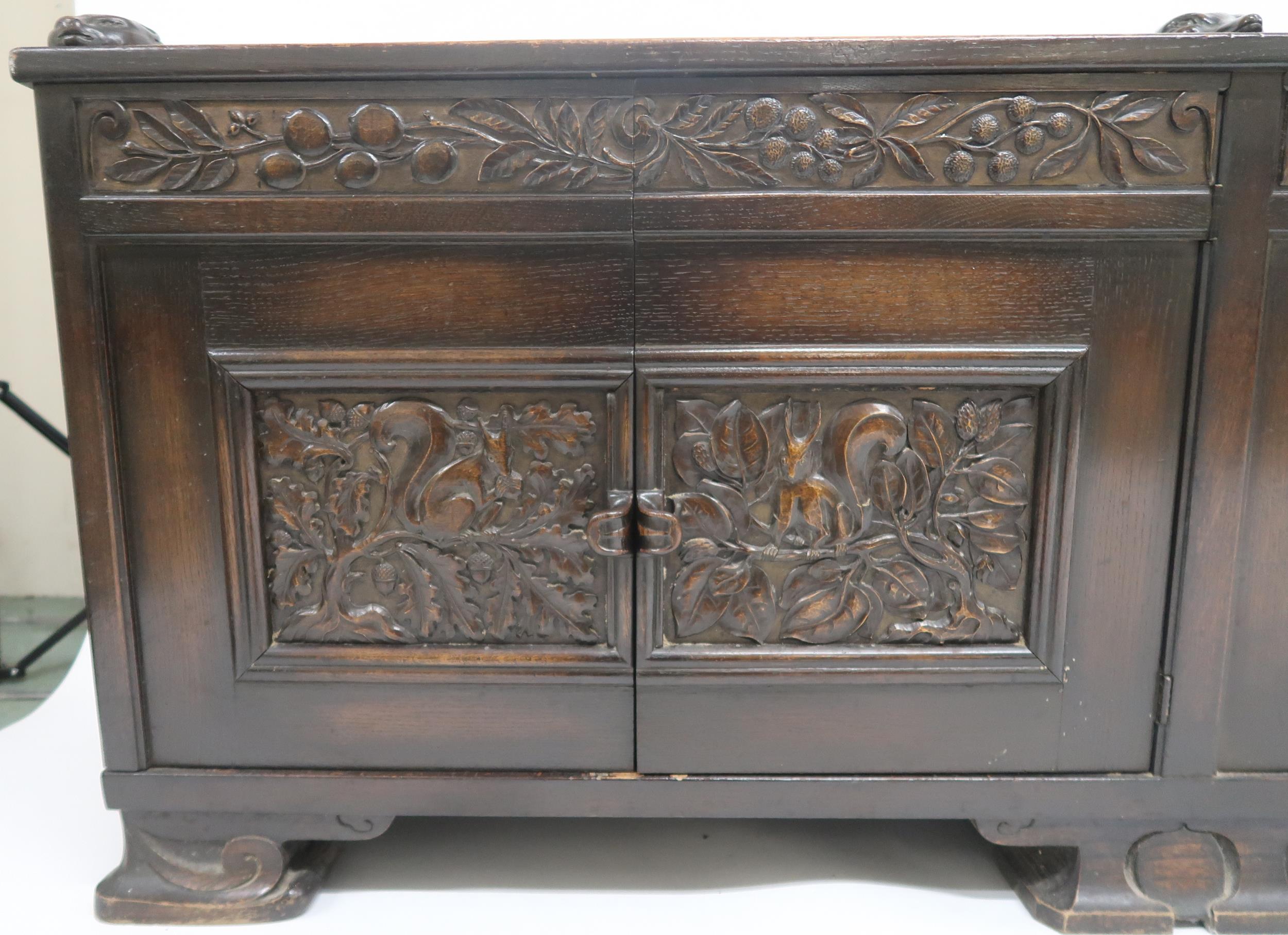 AN ARTS AND CRAFTS OAK AND BURR WALNUT COFFER the three section hinged top carved with foxes and - Image 9 of 16