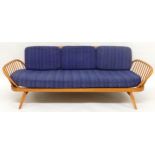 A MID 20TH CENTURY ELM AND BEECH FRAMED ERCOL DAY BED with blue upholstered cushions, 76cm high x