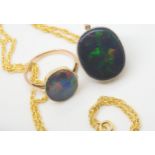 A BLACK OPAL PENDANT WITH SIMILAR RING the pendant mounted in 9ct gold appears to be a solid piece