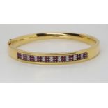 AN 18CT GOLD RUBY AND DIAMOND BANGLE made by Lime Blue, full London import marks. with a diamond