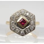 A STATEMENT RUBY & DIAMOND CLUSTER RING set with a square ruby of approx 3.7mm x 3.7mm x 2.6mm,