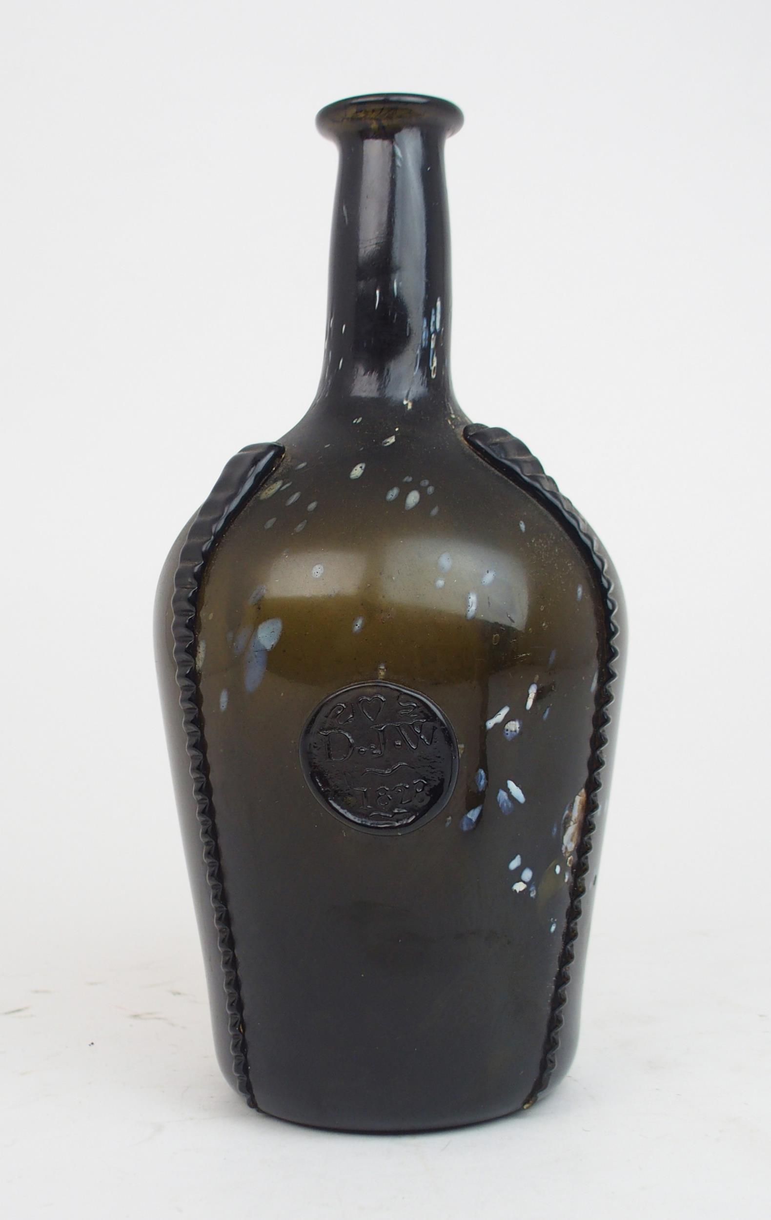 AN EARLY 19TH CENTURY ALLOA GLASS WINE BOTTLE in dark olive green mottled with white splashes,