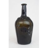 AN EARLY 19TH CENTURY ALLOA GLASS WINE BOTTLE in dark olive green mottled with white splashes,