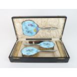 AN ENAMELLED AND SILVER DRESSING TABLE SET with a design after an illustration by Margaret W Tarrant