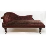 A VICTORIAN MAHOGANY FRAMED CHAISE LONGUE with foliate carvings, buttonback and seat upholstered