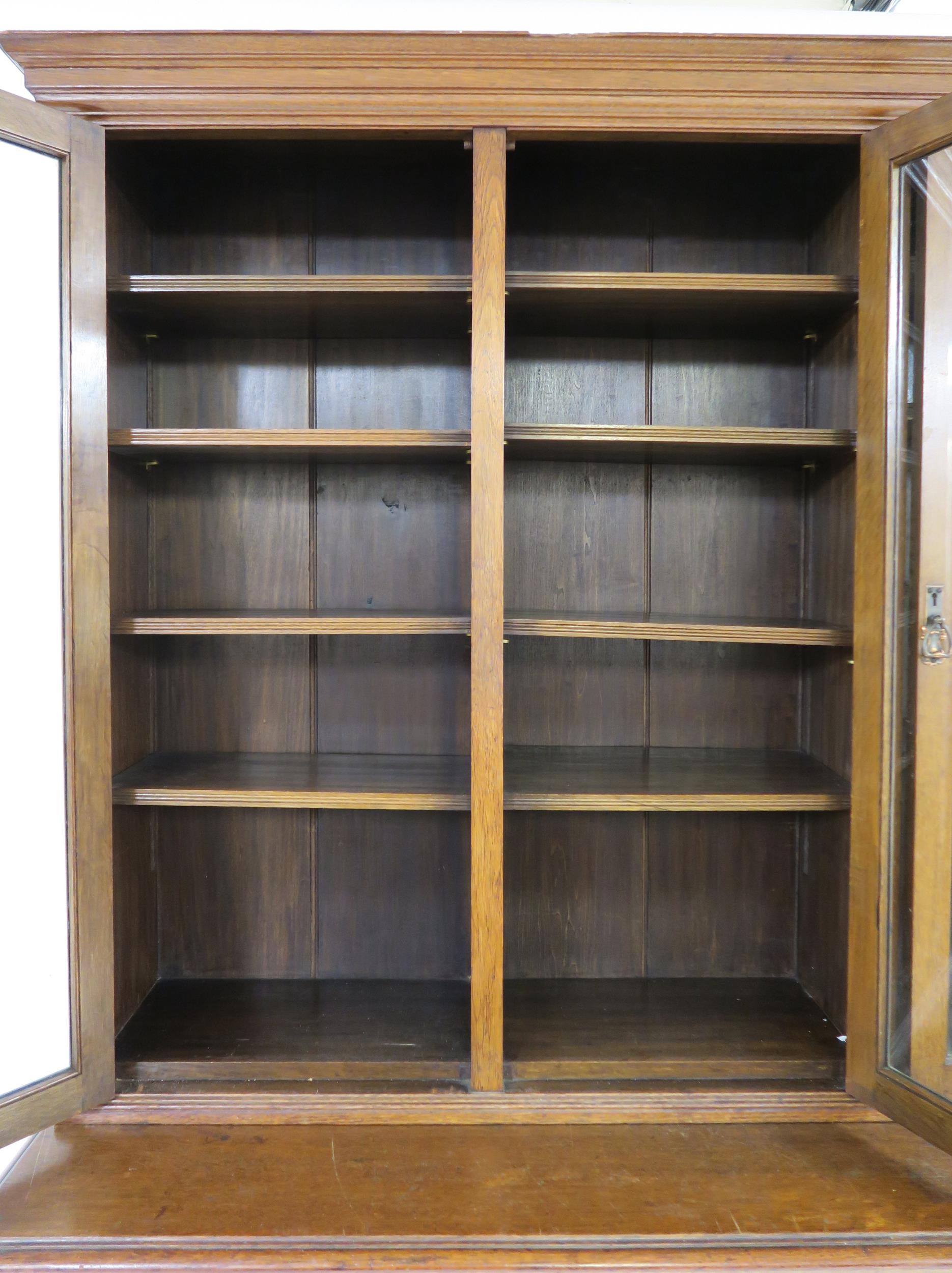 A LATE VICTORIAN OAK ARTS & CRAFTS BOOKCASE with moulded cornice over three glazed doors over two - Image 8 of 9