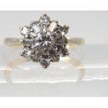 A DIAMOND CLUSTER RING set with estimated approx 0.68cts of brilliant and baguette cut diamonds, set