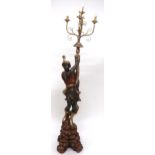 A 20TH CENTURY CARVED WOOD BLACKAMOOR STANDARD LAMP with gilt five branch foliate light mount held