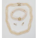 PEARLS WITH A FANCY DIAMOND CLASP The double string of pearls are uniform in size, approx 5.6mm, the