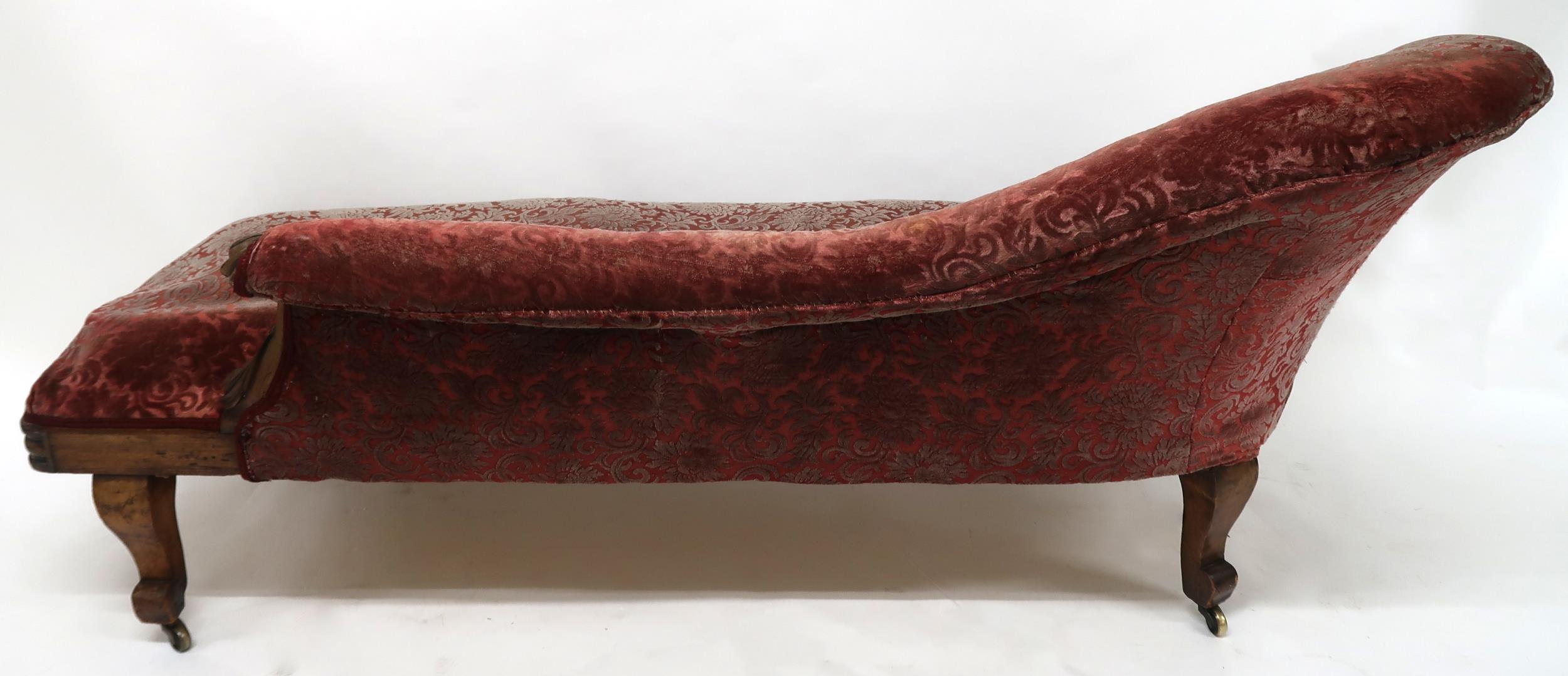 A VICTORIAN MAHOGANY FRAMED CHAISE LONGUE with foliate carvings, buttonback and seat upholstered - Image 8 of 8