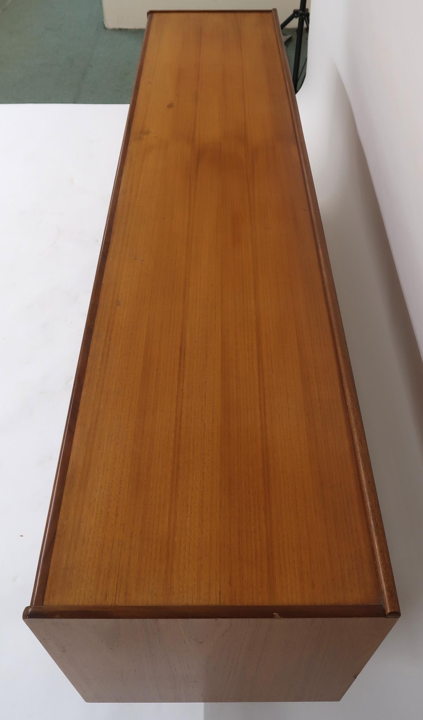 A MID 20TH CENTURY TEAK SIDEBOARD with three long central drawers flanked by cabinet doors with - Image 9 of 12