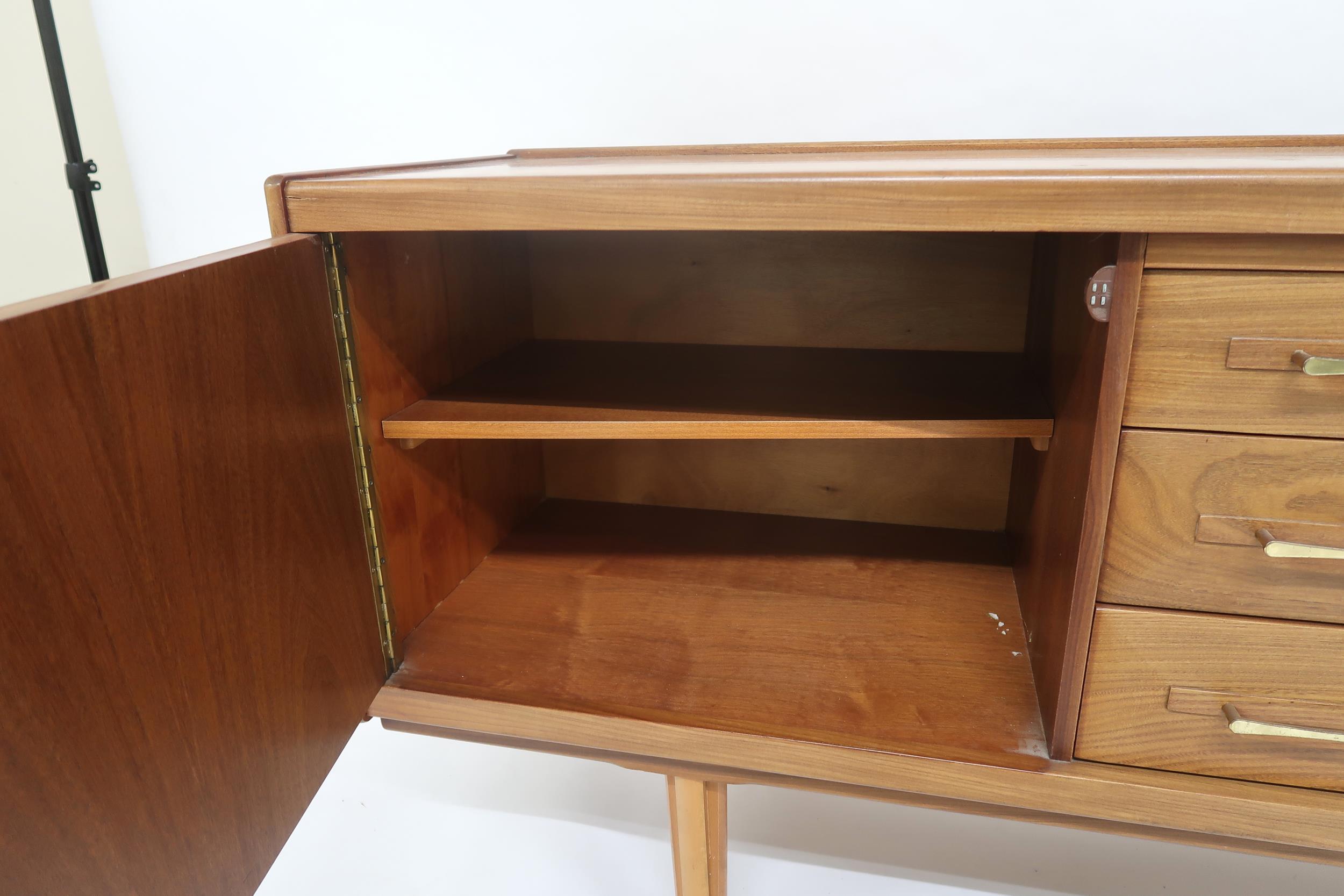 A MID 20TH CENTURY TEAK SIDEBOARD with three long central drawers flanked by cabinet doors with - Image 6 of 12