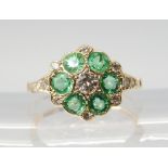 AN EMERALD & DIAMOND FLOWER RING set throughout in 15ct gold, finger size N, weight 2.4gms Condition