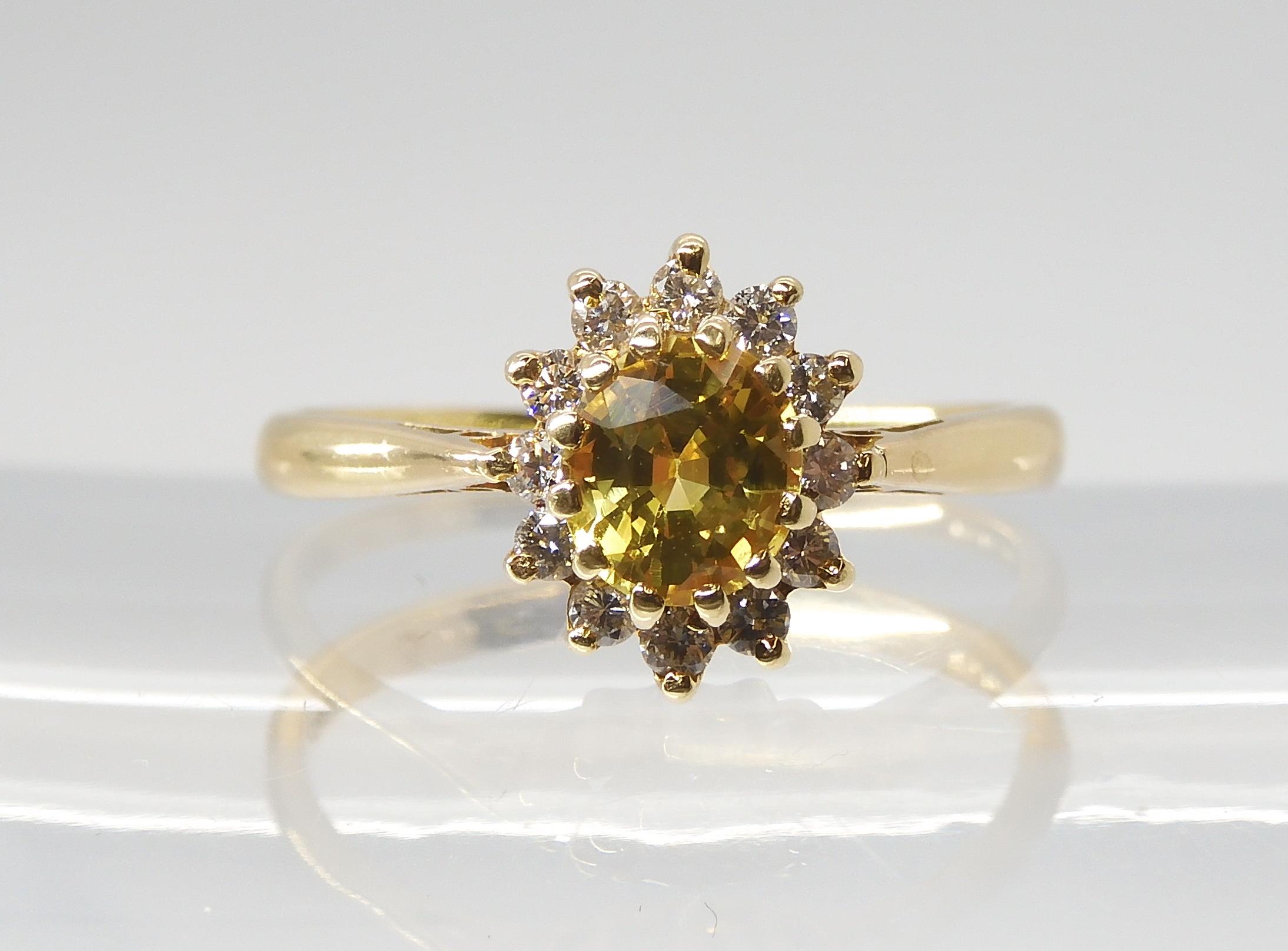 A YELLOW SAPPHIRE AND DIAMOND CLUSTER RING set throughout in 18ct yellow gold, finger size N, weight