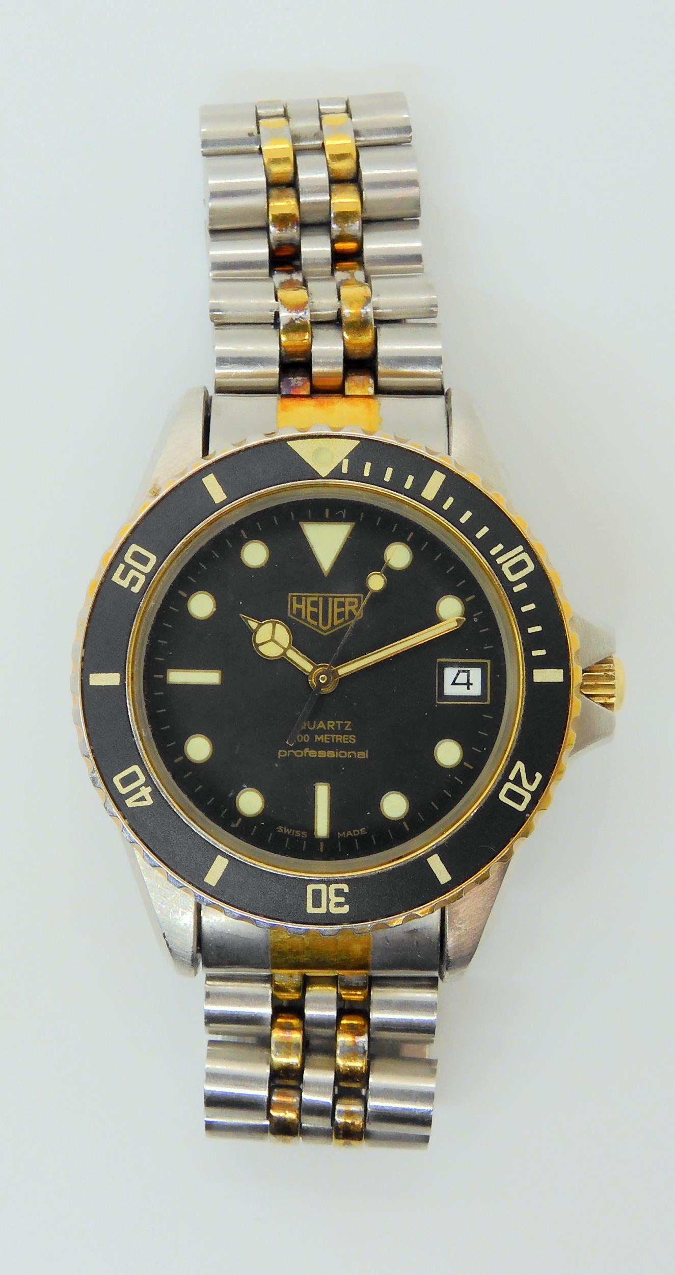 A VINTAGE HEUER WRISTWATCH circa 1983, steel and gold plate diver's watch.  The watch has a black