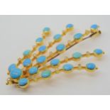 A TURQUOISE AND DIAMOND STATEMENT BROOCH set throughout in yellow metal the oval and round