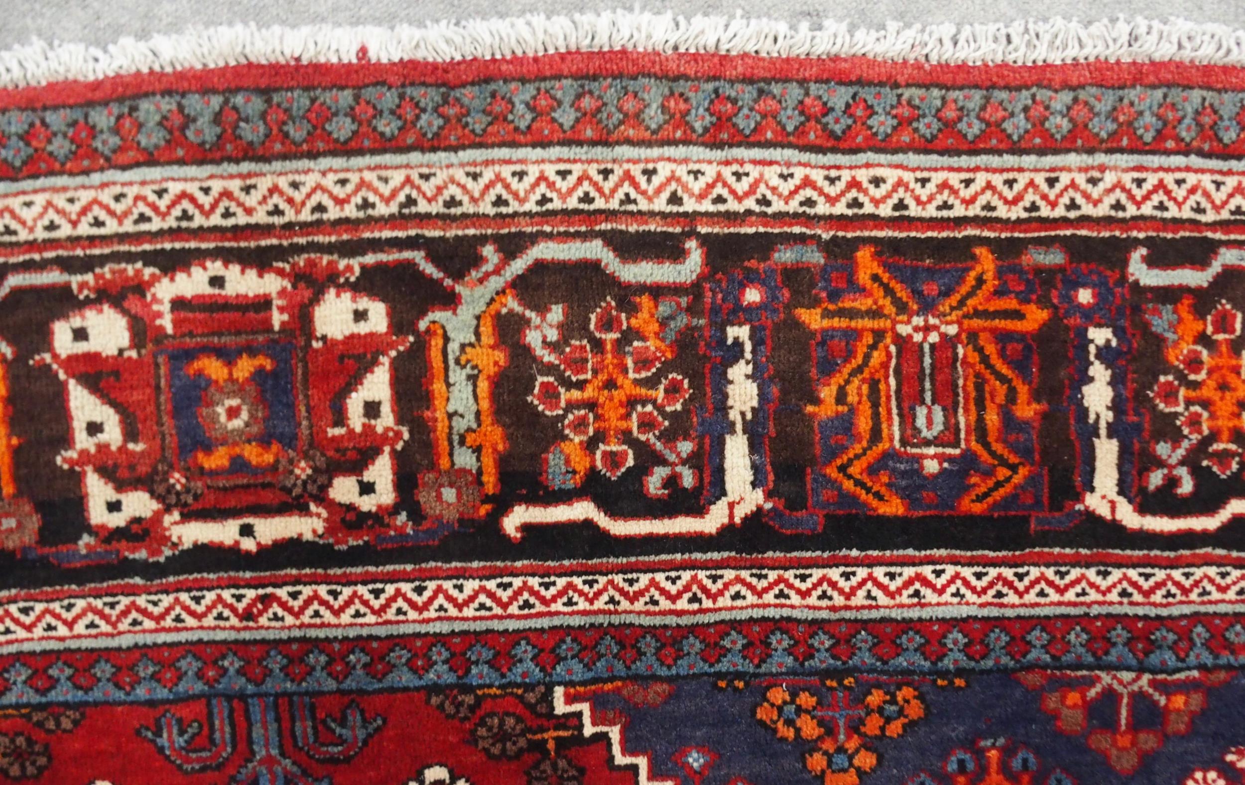 A RED GROUND MEIMEH RUG with dark blue central medallion, matching spandrels and dark blue flower - Image 7 of 10