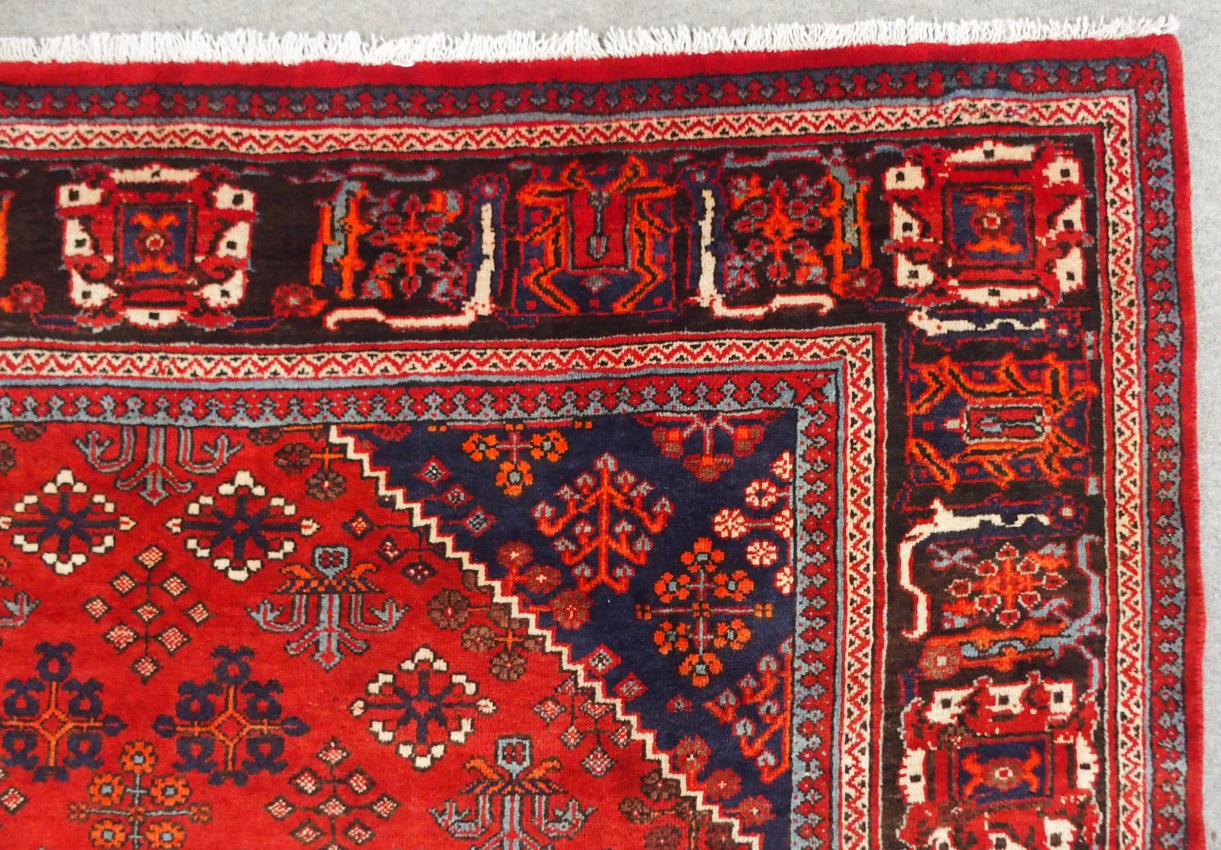 A RED GROUND MEIMEH RUG with dark blue central medallion, matching spandrels and dark blue flower - Image 3 of 10