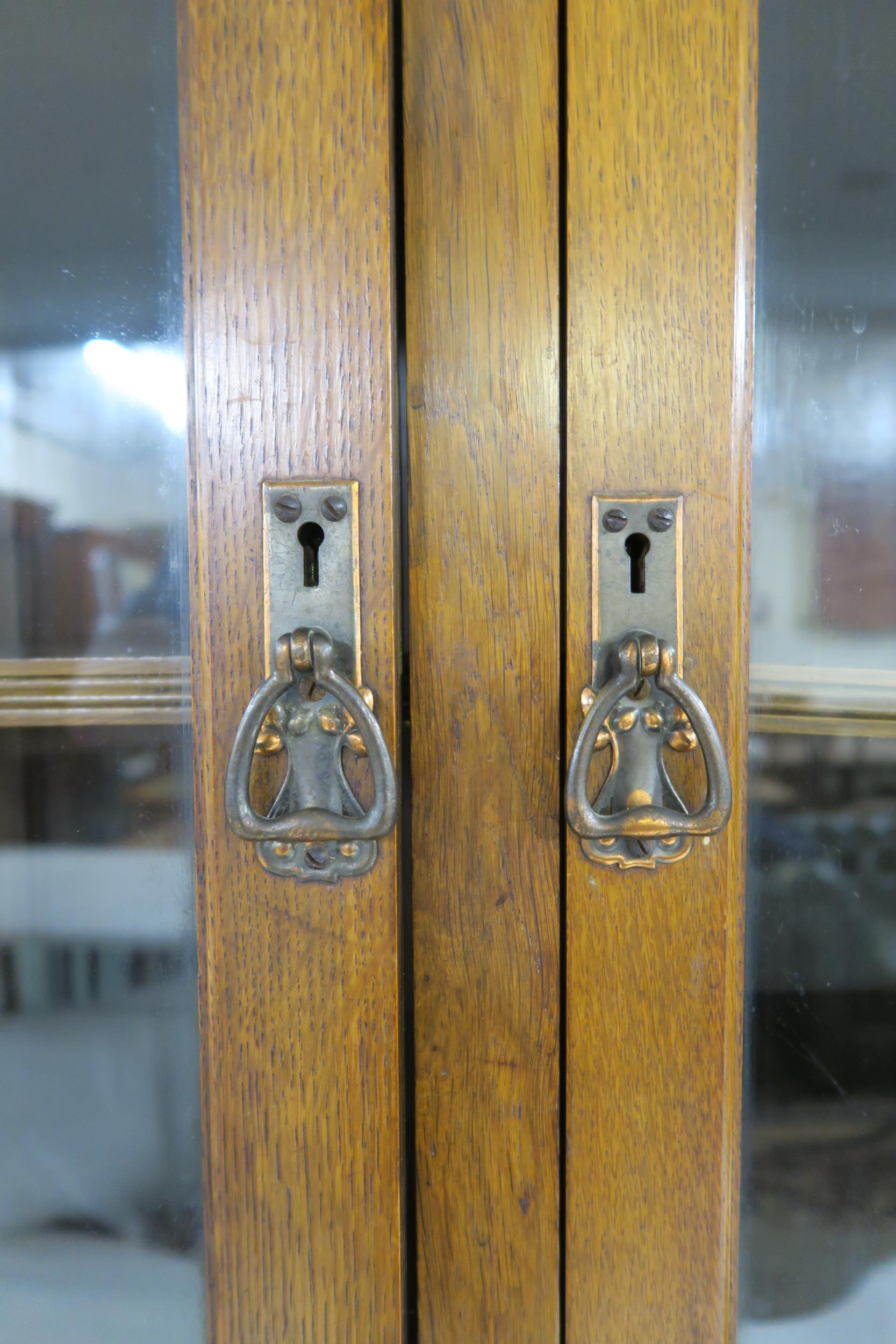 A LATE VICTORIAN OAK ARTS & CRAFTS BOOKCASE with moulded cornice over three glazed doors over two - Image 7 of 9