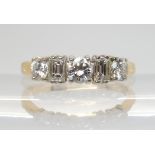 A BRILLIANT AND BAGUETTE CUT DIAMOND RING mounted in 18ct yellow and white gold, set with