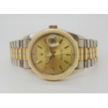 A ROLEX OYSTER PERPETUAL DAYDATE with gold coloured dial gold baton numerals, day and date