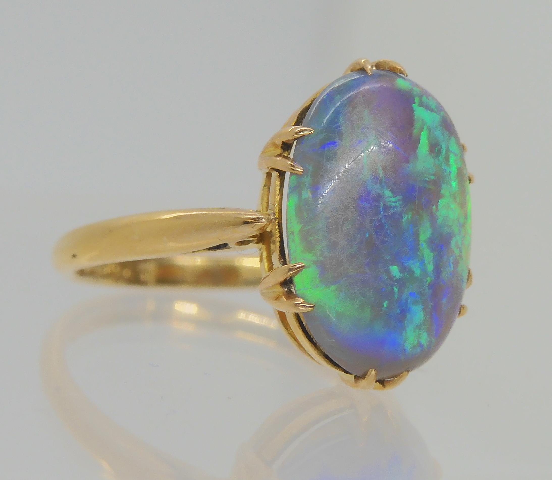 AN OPAL RING AND OTHER ITEMS The solid black opal has lively green, purple and blue colour play, and - Image 4 of 15