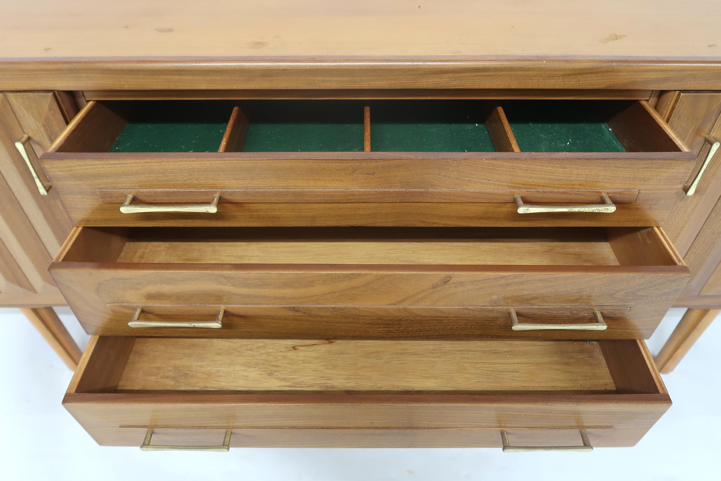 A MID 20TH CENTURY TEAK SIDEBOARD with three long central drawers flanked by cabinet doors with - Image 7 of 12