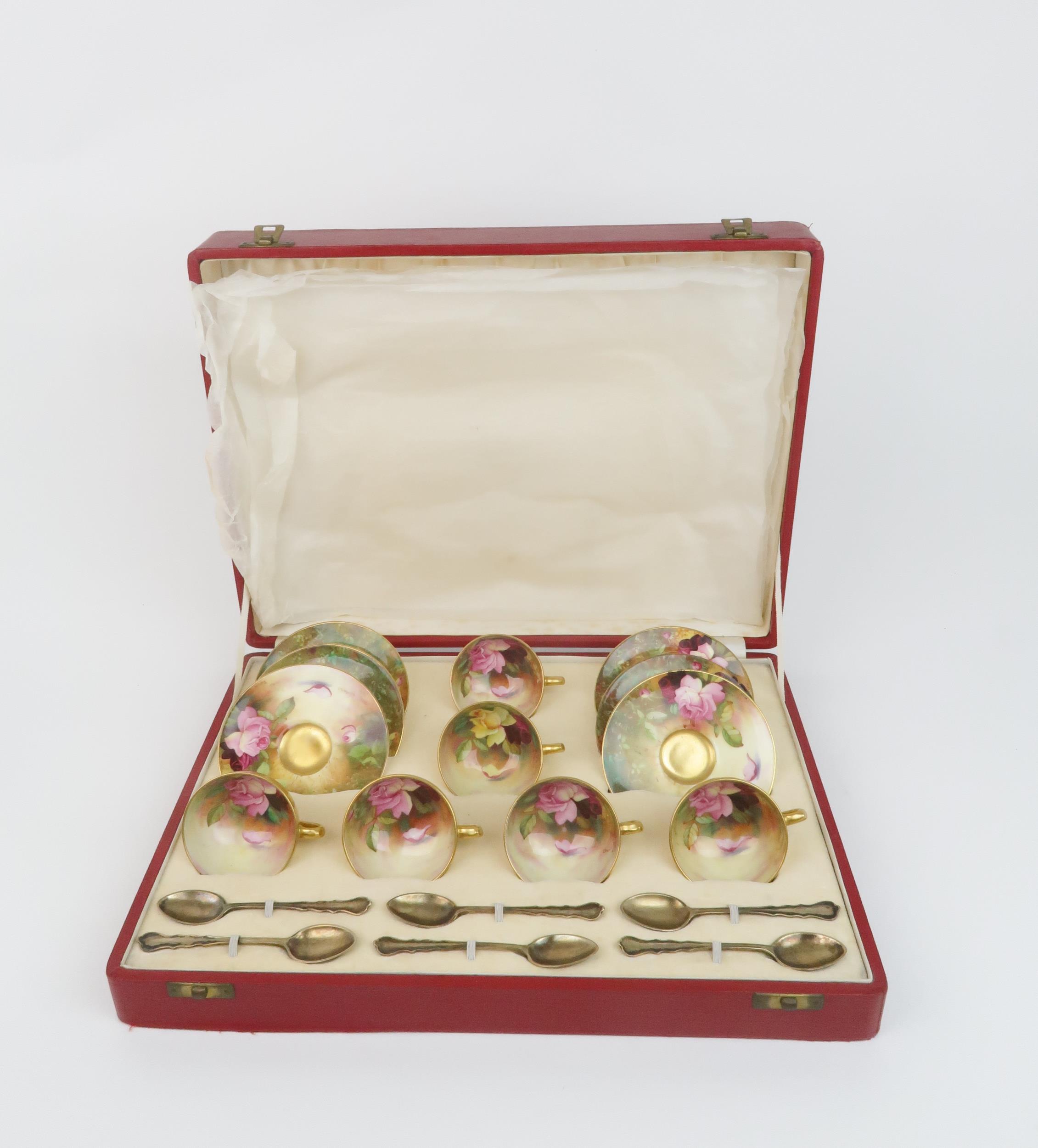A ROYAL WORCESTER BOXED SET OF SIX DEMITASSE COFFEE CUPS AND SAUCERS each painted with roses in a