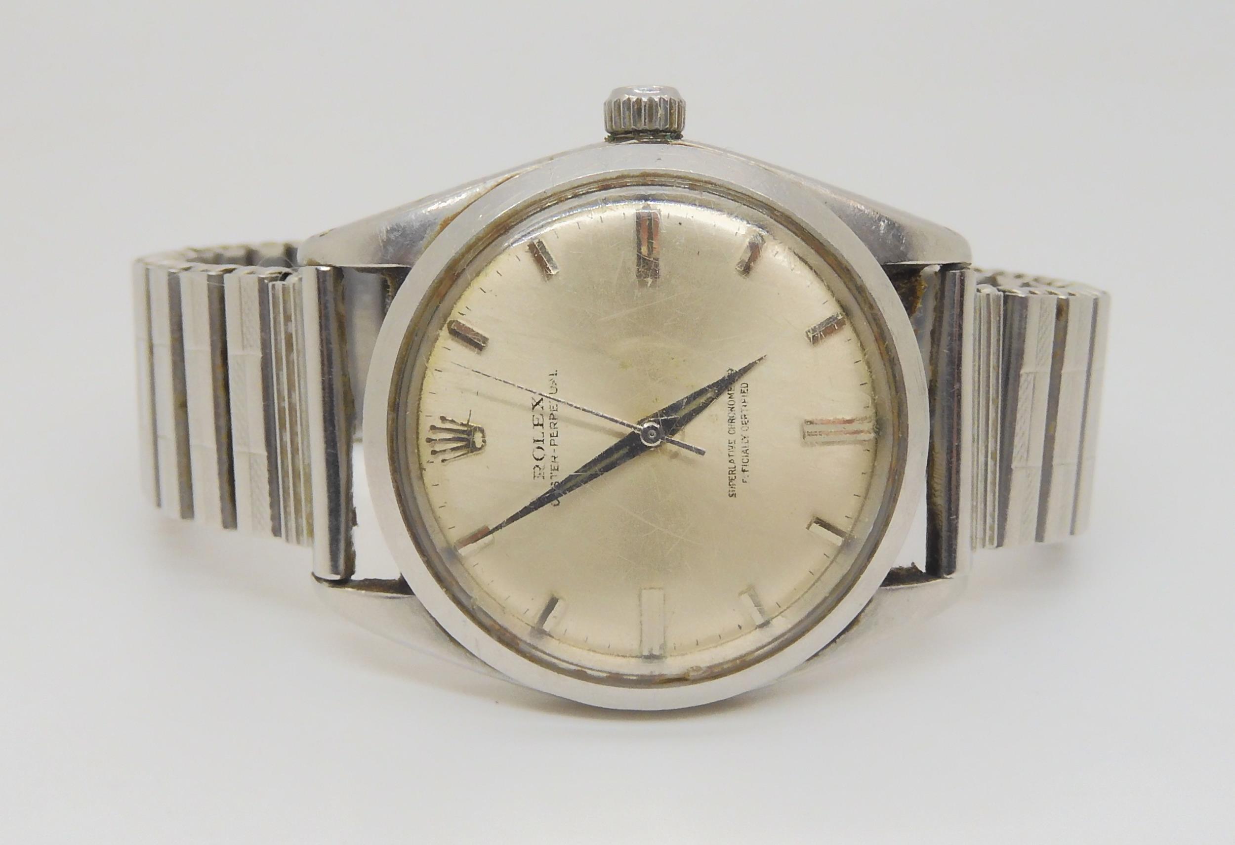 A STAINLESS STEEL ROLEX OYSTER PERPETUAL with silvered dial, silver coloured baton numerals and