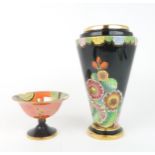 A CARLTON WARE HOLLYHOCKS PATTERN VASE of tapering form with black ground and green interior,