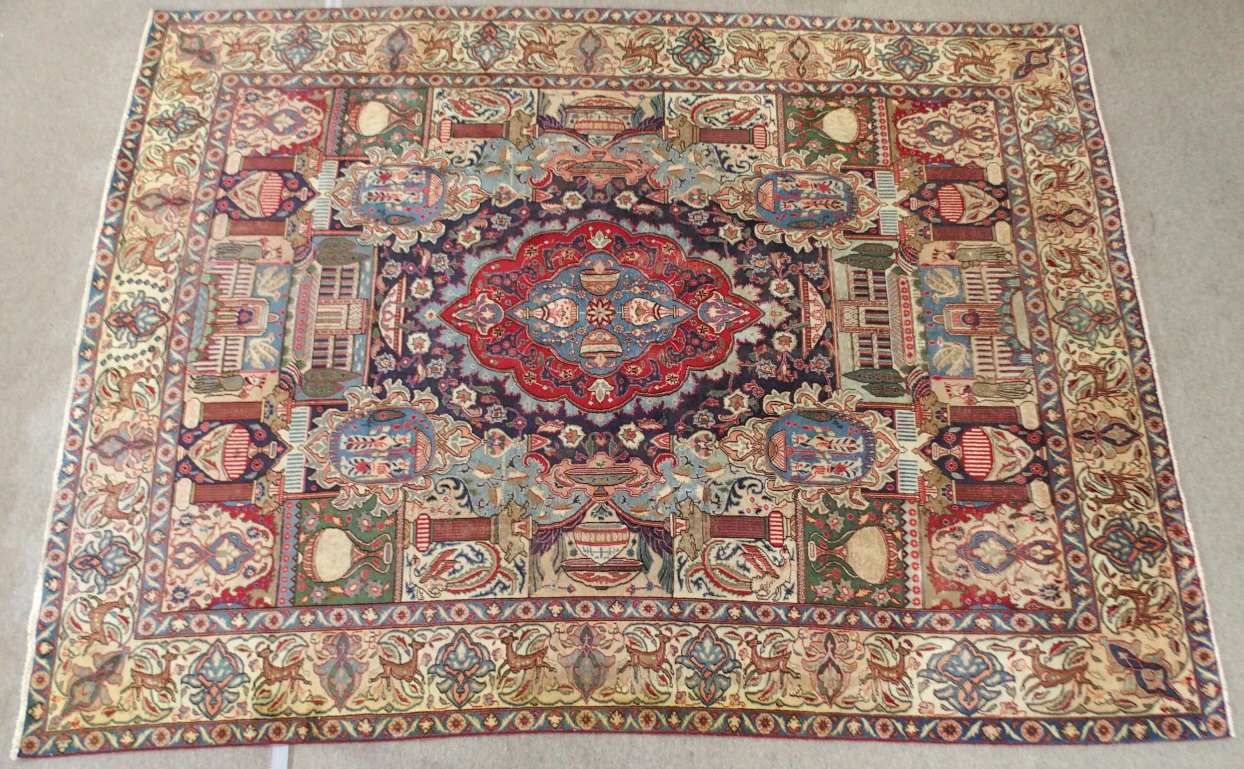 A MULTICOLOURED GROUND KASHMAR RUG with red and blue central medallion upon an extensively decorated