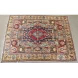 A MULTICOLOURED GROUND KASHMAR RUG with red and blue central medallion upon an extensively decorated