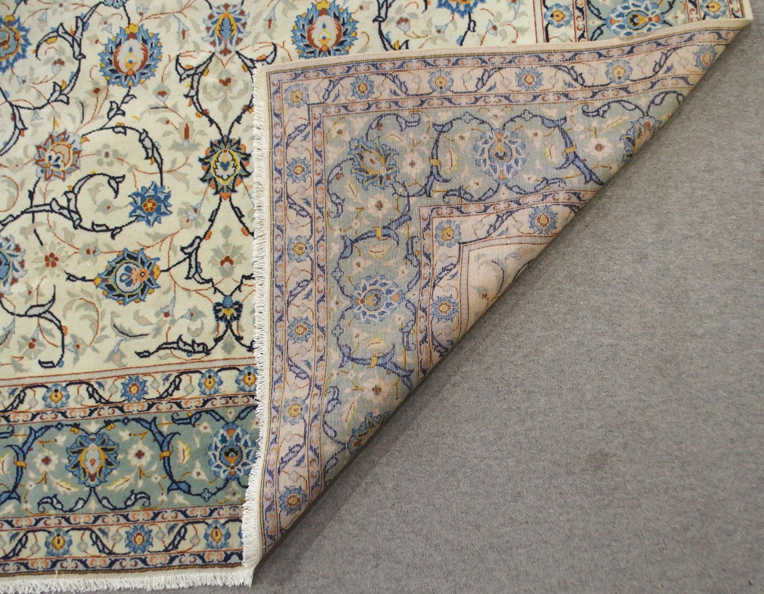 A CREAM GROUND KASHAN RUG with all-over floral design and flower head border, 361cm long x 242cm - Image 7 of 8